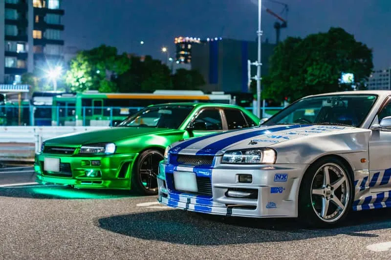 JDM sports cars lined up at the Daikoku Parking Area car meet on a Fast and Furious Tokyo drift ride in Japan
