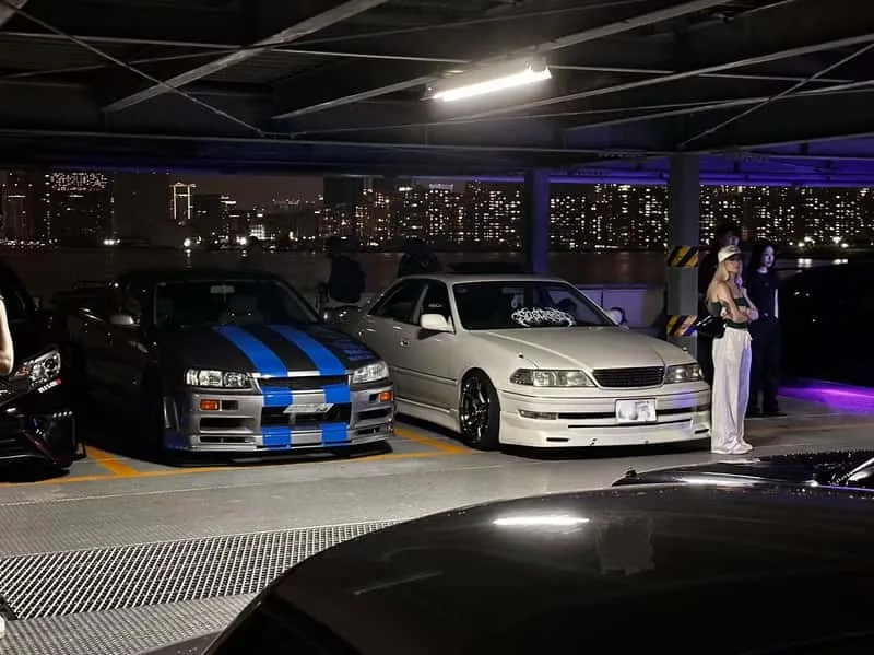 Turbocharged JDM engine bay glowing at night on a Tokyo drift JDM car meet and engine sound tour in Japan